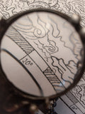 Pendant with natural stone - indian agat, magnifying glass and hand-drawn compass under another magnifying glass. For Men and Women